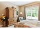 Bedroom featuring a decorative armoire, window, and chair at 3399 Nottinghill Blvd, Plainfield, IN 46168