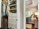 Walk-in closet leading to the main bedroom with custom shelving, storage, and an ottoman at 3399 Nottinghill Blvd, Plainfield, IN 46168
