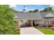 Charming home featuring brick and stone accents, a covered carport, and manicured lawn at 3399 Nottinghill Blvd, Plainfield, IN 46168