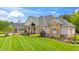 Charming home featuring brick and stone accents, a covered porch, and manicured lawn at 3399 Nottinghill Blvd, Plainfield, IN 46168