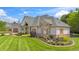 Charming home featuring brick and stone accents, a covered porch, and manicured lawn at 3399 Nottinghill Blvd, Plainfield, IN 46168