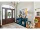 Charming foyer featuring a decorative front door, console table, and warm, inviting decor at 3399 Nottinghill Blvd, Plainfield, IN 46168