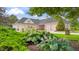 Spacious four-car garage with well-maintained landscaping and brick accents at 3399 Nottinghill Blvd, Plainfield, IN 46168