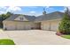 Spacious four-car garage with well-maintained landscaping and brick accents at 3399 Nottinghill Blvd, Plainfield, IN 46168