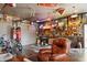 Garage with rustic decor, neon signs, a leather chair, and various recreational items at 3399 Nottinghill Blvd, Plainfield, IN 46168