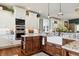 Bright eat-in kitchen with granite counters, a farmhouse sink, stainless appliances, and dark wood and white cabinets at 3399 Nottinghill Blvd, Plainfield, IN 46168