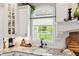 Charming kitchen with a granite countertop, white cabinets, undermount sink, and bright window overlooking yard at 3399 Nottinghill Blvd, Plainfield, IN 46168