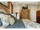 Stylishly appointed main bedroom with an armoire and a view of the ensuite bathroom at 3399 Nottinghill Blvd, Plainfield, IN 46168