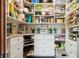 Well-organized walk-in pantry with ample shelving, drawers, and counter space for kitchen storage at 3399 Nottinghill Blvd, Plainfield, IN 46168