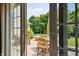 View from the main bedroom of a cozy patio with an outdoor dining set and refreshing pool at 3399 Nottinghill Blvd, Plainfield, IN 46168