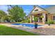 Backyard pool with lounge chairs, well-manicured lawn and patio, perfect for entertaining at 3399 Nottinghill Blvd, Plainfield, IN 46168