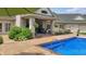 Inviting backyard pool with patio area, lush landscaping, and lovely home exterior at 3399 Nottinghill Blvd, Plainfield, IN 46168