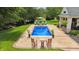 Beautiful backyard with a pool, patio set, and lush landscaping, perfect for outdoor living at 3399 Nottinghill Blvd, Plainfield, IN 46168