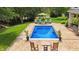 Serene backyard pool with inviting patio seating and lush green landscaping at 3399 Nottinghill Blvd, Plainfield, IN 46168