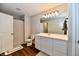 Bright bathroom featuring a white double vanity, large mirror, and shower with neutral-toned curtain at 3443 Thomas Jefferson St, Westfield, IN 46074