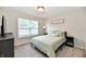 Cozy bedroom features a comfortable bed, window with blinds, and neutral decor at 3443 Thomas Jefferson St, Westfield, IN 46074