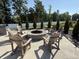 Community fire pit with seating and mature landscaping, perfect for outdoor gatherings at 3443 Thomas Jefferson St, Westfield, IN 46074