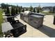 Outdoor kitchen and grilling area with stainless steel grill and stone countertops at 3443 Thomas Jefferson St, Westfield, IN 46074