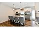 Well-appointed kitchen featuring a center island with seating, ample cabinet space, and stainless appliances at 3443 Thomas Jefferson St, Westfield, IN 46074