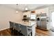 Bright kitchen features white cabinetry, stainless steel appliances, and a large island with seating at 3443 Thomas Jefferson St, Westfield, IN 46074