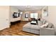 Well-lit living room with modern furnishings, a large TV, and easy access to other areas of the home at 3443 Thomas Jefferson St, Westfield, IN 46074