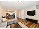 Open-concept living room features a modern design, TV, and seamless flow into the kitchen and dining area at 3443 Thomas Jefferson St, Westfield, IN 46074