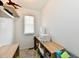 Compact office space with natural light, featuring shelving and a small desk setup at 3443 Thomas Jefferson St, Westfield, IN 46074