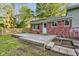 Exterior view of a home featuring a wooden deck, brick exterior, white trim and a fenced-in yard at 3518 Woodale Rd, Indianapolis, IN 46234