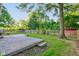 Fenced-in backyard with a wooden deck and mature trees offers plenty of outdoor living space at 3518 Woodale Rd, Indianapolis, IN 46234