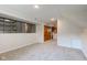 Basement view showing carpeting, built-in storage, and laundry area at 3518 Woodale Rd, Indianapolis, IN 46234