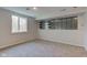 Finished basement with carpet, window, and unique shelving detail for extra storage at 3518 Woodale Rd, Indianapolis, IN 46234