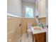 Bathroom with tiled walls, toilet and vanity with marble top at 3518 Woodale Rd, Indianapolis, IN 46234