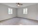 Neutral bedroom featuring two windows, carpet, and a ceiling fan for added comfort at 3518 Woodale Rd, Indianapolis, IN 46234