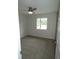 Cozy bedroom with neutral paint, new carpet, a modern ceiling fan and a large window for natural light at 3518 Woodale Rd, Indianapolis, IN 46234