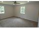 Bright bedroom features neutral carpet, paint, and a ceiling fan at 3518 Woodale Rd, Indianapolis, IN 46234