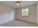 This bedroom features carpet, a ceiling fan, and a window to let in natural light at 3518 Woodale Rd, Indianapolis, IN 46234