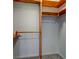 Walk-in closet with wooden shelves and rods for organized storage at 3518 Woodale Rd, Indianapolis, IN 46234