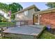 Charming two-story home with a brick and siding exterior, a deck, and mature landscaping at 3518 Woodale Rd, Indianapolis, IN 46234