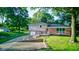 Charming two-story home with a well-maintained lawn, mature trees, and paved driveway at 3518 Woodale Rd, Indianapolis, IN 46234