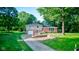 Charming two-story home with a well-maintained lawn, mature trees, and a paved driveway at 3518 Woodale Rd, Indianapolis, IN 46234