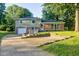 Charming two-story home with a brick and siding exterior, a spacious driveway, and mature trees at 3518 Woodale Rd, Indianapolis, IN 46234