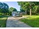 Charming two-story home with a brick and siding exterior, a spacious driveway, and mature trees at 3518 Woodale Rd, Indianapolis, IN 46234