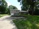 Charming two-story home with a brick and siding exterior, lovely landscaping, and a spacious driveway at 3518 Woodale Rd, Indianapolis, IN 46234