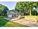 Charming two-story home with a brick and siding exterior, a spacious driveway, and mature trees at 3518 Woodale Rd, Indianapolis, IN 46234