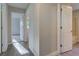 Hallway with wood-look flooring and three doors open to rooms at 3518 Woodale Rd, Indianapolis, IN 46234