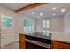 Kitchen island with smooth cooktop, granite countertops and wood cabinetry at 3518 Woodale Rd, Indianapolis, IN 46234