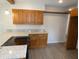 Updated kitchen featuring light countertops, stainless steel appliances, laminate floors and wood cabinets at 3518 Woodale Rd, Indianapolis, IN 46234
