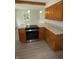 Stylish kitchen featuring light countertops, stainless steel appliances, laminate floors, and wood cabinets at 3518 Woodale Rd, Indianapolis, IN 46234