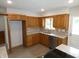 Well-equipped kitchen with stainless steel appliances, light countertops, and rich wood cabinetry at 3518 Woodale Rd, Indianapolis, IN 46234