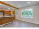 Kitchen with wood cabinetry, stainless steel appliances and an eat-in area filled with natural light at 3518 Woodale Rd, Indianapolis, IN 46234